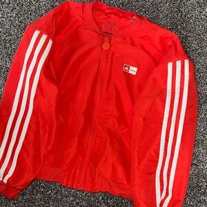 Unisex adidas track jacket, Disney collection. Red with stripes.